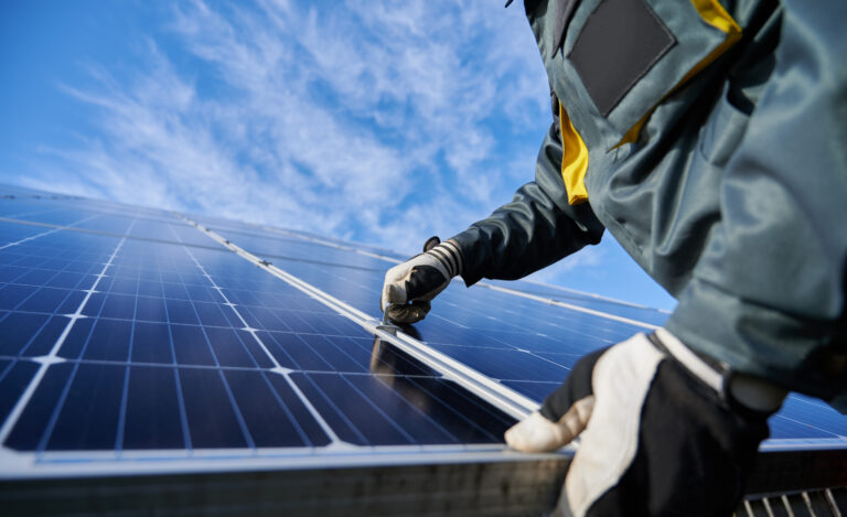 Energy Sovereignty: A Grenadian Imperative for Geopolitical Uncertainty male worker repairing photovoltaic solar panel.